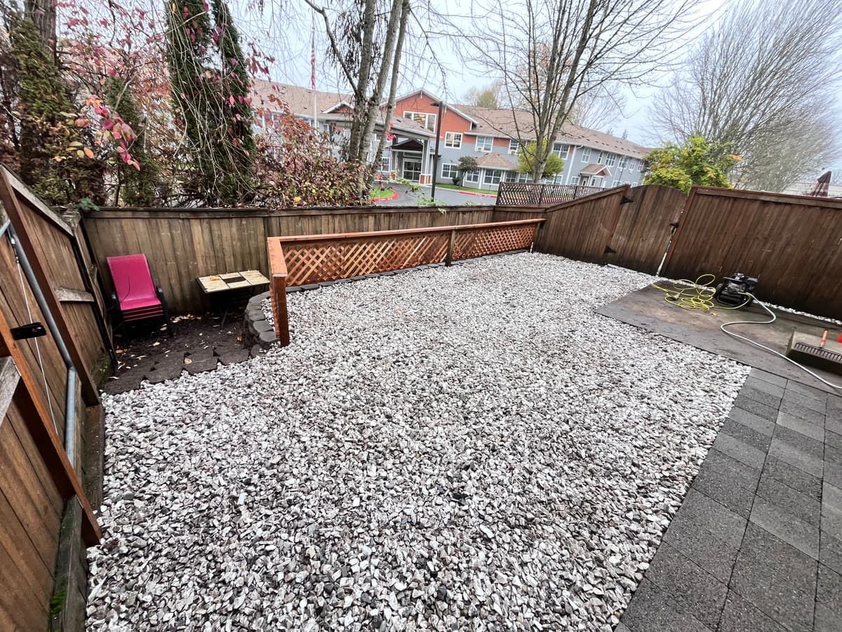 Finished back yard in gravel with a paver border, by Handy Brothers LLC